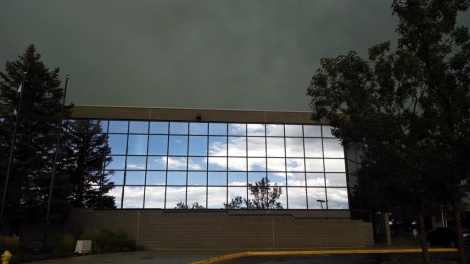 Blue skies in the reflection of the USAP building as the storm passes
